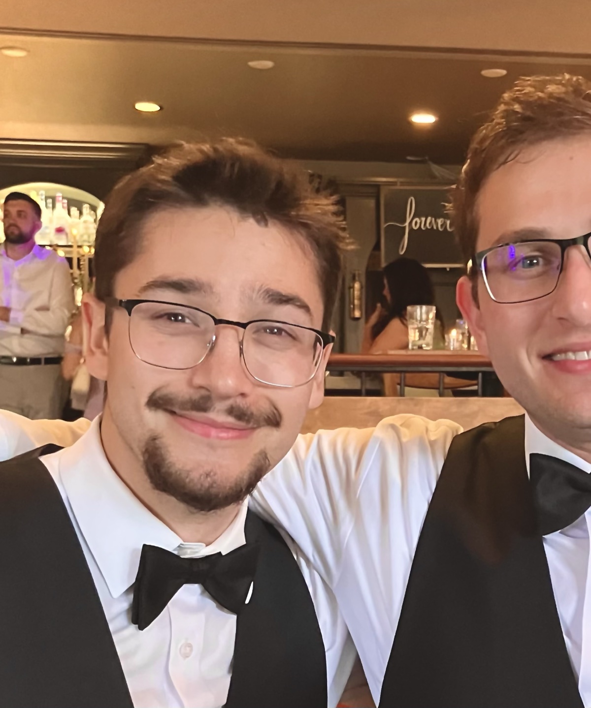 Ted, in a vest and bow tie, at a wedding